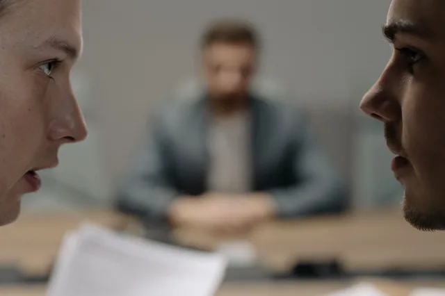Close-up of two men in a serious discussion at a business meeting. How interview courses differ by the goal you have