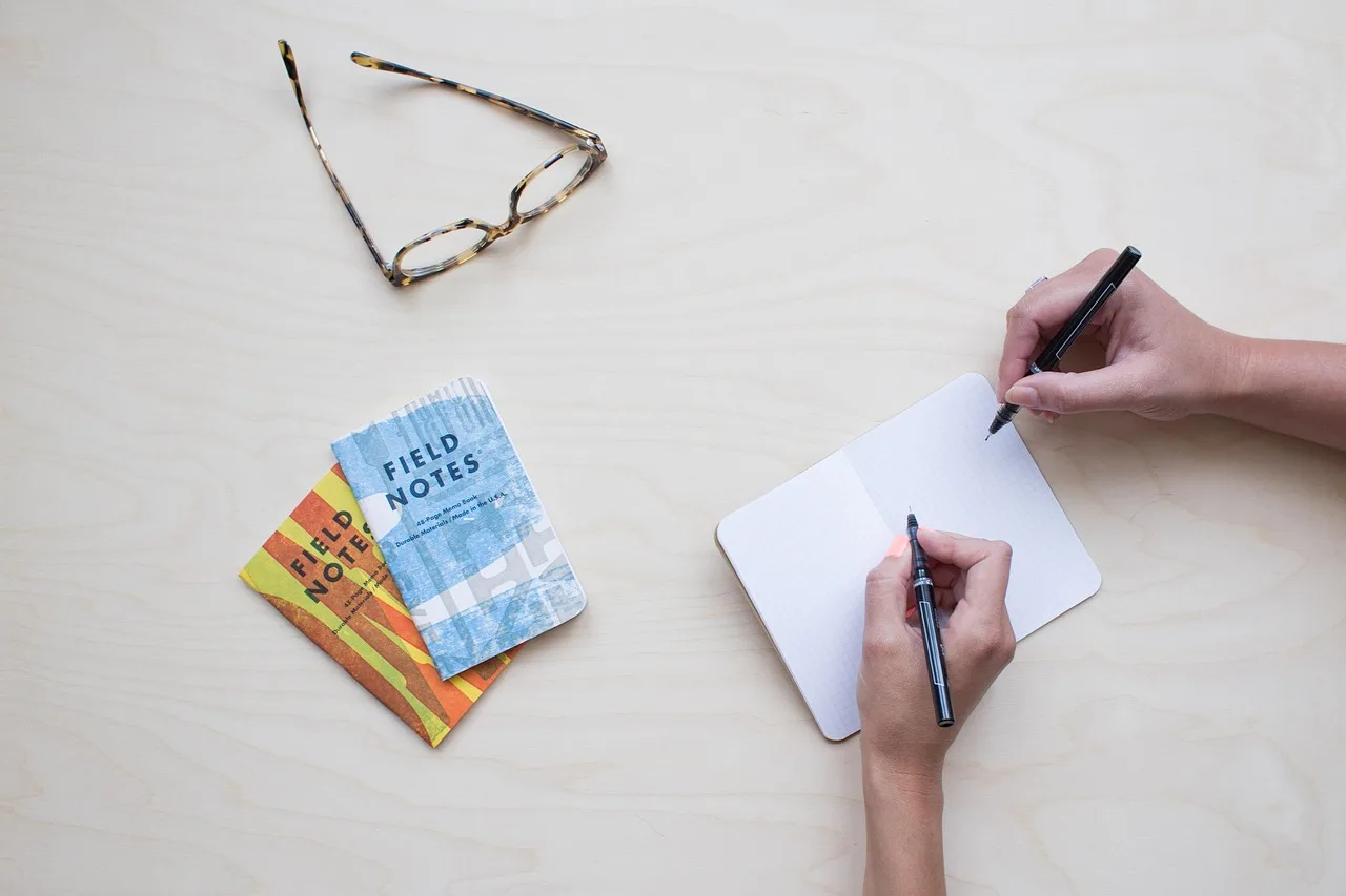 notes, glasses, table, business, office, desk, people, work, pen, notepad, pen and paper, person, notebook. Project management salary guide for US tech hubs
